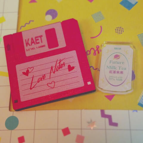 floppy disk wooden pin and "Future Milk Tea" acrylic pin