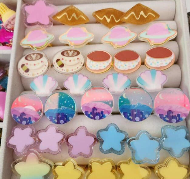 Assortment of adjustable rings, all hand-assembled - star, sopaipillas, planets, coffee cup, doriyaki, seashell, Sailor Moon inspired skylines (pink - Albuquerque, teal - Denver) stars (alternate colors)